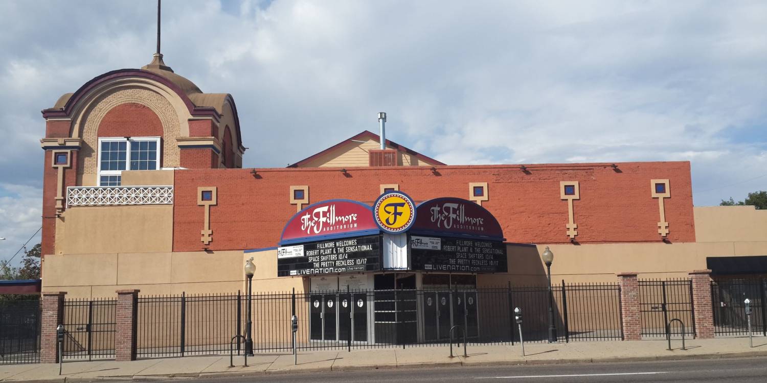 Fillmore Auditorium exterior, with a brick facade, curved marquee and black entrance fence